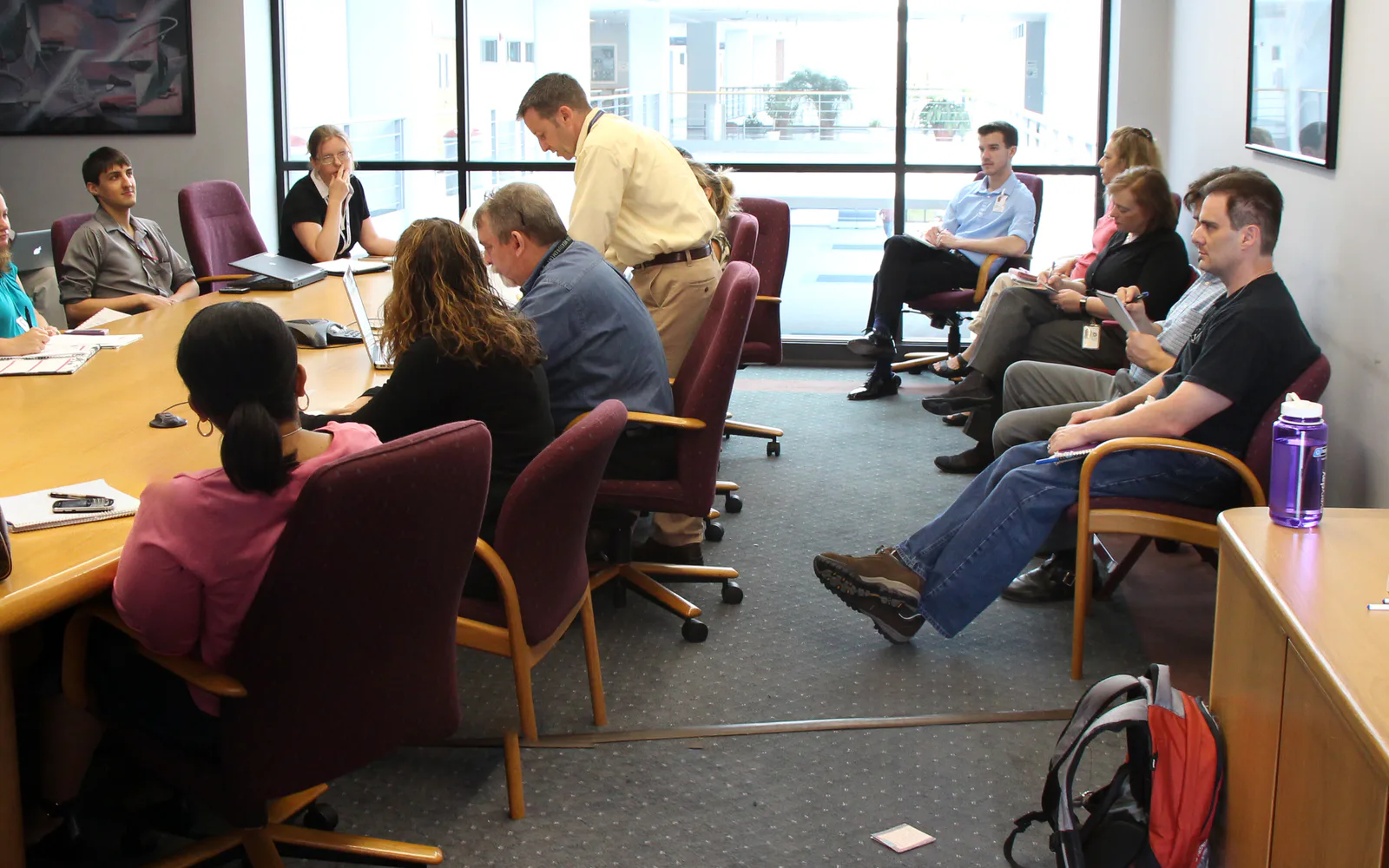 People taking part in a working meeting around a conference table